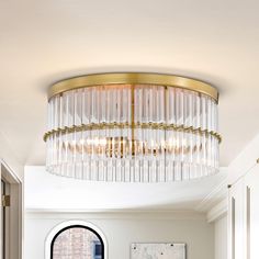 a living room filled with furniture and a round chandelier above the couches