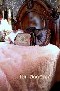 a bed with pink fur and pillows on it