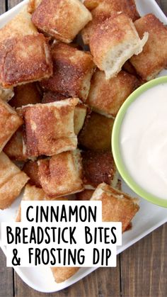 a white plate topped with croutons next to a bowl of ranch dressing