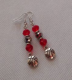 Show your team spirit with these scarlet and gray basketball theme earrings.   The design incorporates 8mm scarlet red and gray beads, stainless steel  accents, and a basketball charm.  Be sure and review the photo that shows the overall drop of the earrings and the charm.  Stainless steel fishhooks are used for these earrings.  These will sell fast! My shop offers combines shipping.  Select multiple items on once invoice and pay one flat shipping fee.  This is a great deal for shoppers! All ite Cheap Sporty Earrings For Sports, Ohio State Colors, Basketball Earrings, Beaded Napkin Rings, Football Earrings, Basketball Theme, Grey Beads, Arkansas Razorbacks, A Basketball