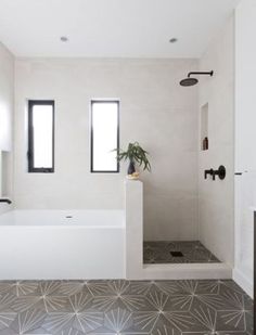 a bathroom with a large bathtub and two windows