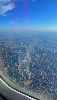 the view from an airplane window looking down on new york city and its surrounding skyscrapers