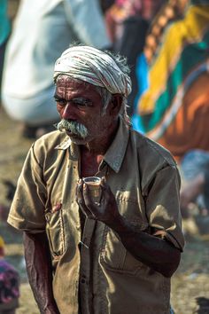 an old man with a white turban and a moustache on his face