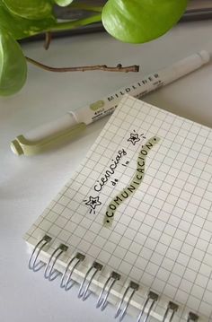 a notepad with the words congratulations written on it next to a pen and plant