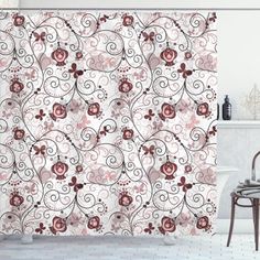 the shower curtain is decorated with pink and red flowers