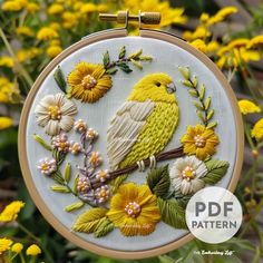 a yellow bird is sitting on a branch with flowers