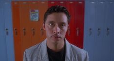 a man with a mustache standing in front of lockers