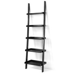 a black shelf with three shelves on each side and one is leaning against the wall