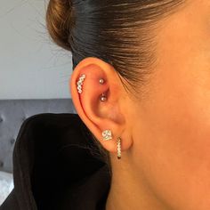 a close up of a person with ear piercings on their left and right sides