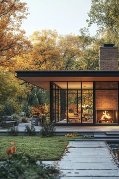 a modern house with a fire place in the middle of it's front yard