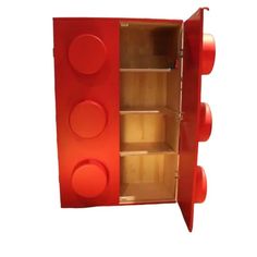 a red toy storage cabinet with wheels and knobs on the front, open to show its contents