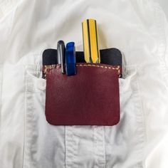 a pocket with pens, pencils and markers sticking out of it's pockets