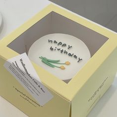 a birthday cake in a box with the words happy birthday written on it