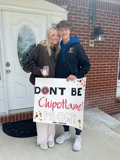 two people holding a sign that says don't be cuppotlame prom