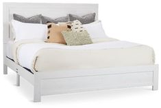 a white bed with two pillows on top of it