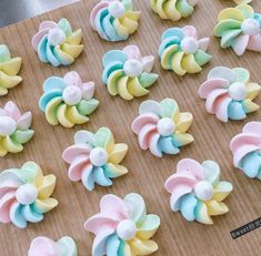 there are many different types of fake flowers on the table with it's icing