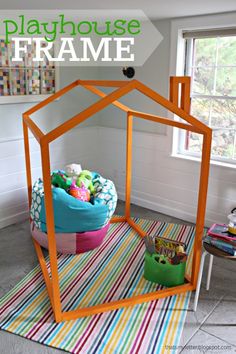 the play house frame is made out of wood and has a colorful rug in front of it