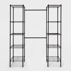 two black shelvings with wire shelves on each side and one shelf below them