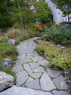 a stone path in front of a house