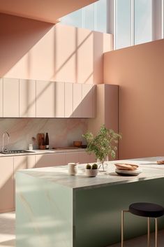 a kitchen with pink walls and counter tops next to a plant in a vase on the island