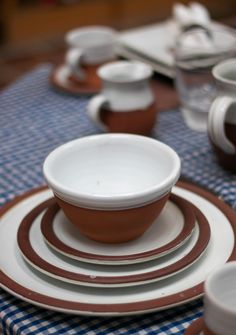 a table set with dishes and cups on it