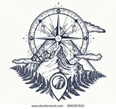 a compass with mountains and trees around it