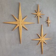 three wooden stars are hanging on the wall