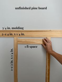 a person is measuring the height of a pine wood frame with measurements for each piece