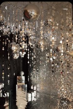 a room filled with lots of shiny balls hanging from the ceiling