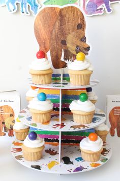 cupcakes are stacked on top of each other in the shape of a bear