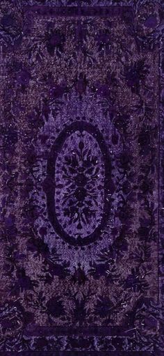 a purple rug with an intricate design on it