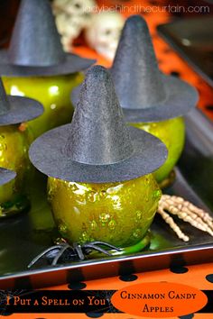 some green apples with witches hats on them