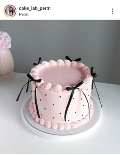 a pink cake sitting on top of a white plate