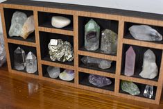 a wooden shelf filled with lots of rocks