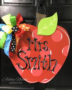 an apple shaped door hanger with the words mrs smith on it and a bow