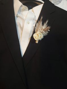 a man in a suit with a boutonniere on his lapel