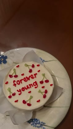 a cake with writing on it sitting on a plate