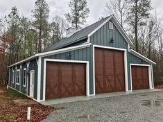 a two car garage in the middle of a wooded area