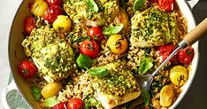 a pan filled with rice, tomatoes and broccoli on top of a table