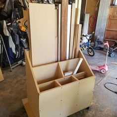 an unfinished storage box is sitting in a garage