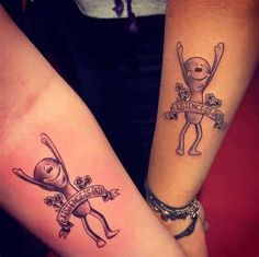 two people with matching tattoos on their arms