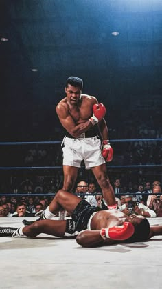 an image of a professional boxing match being watched by the referee and his opponent on the ground