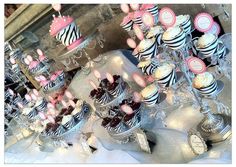 a table topped with lots of cupcakes and cakes