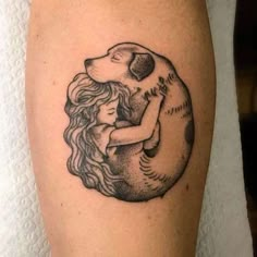 a woman hugging a bear tattoo on the leg