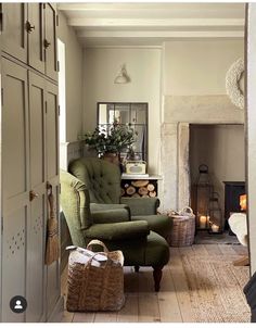 a living room filled with furniture and a fire place next to a doorway that leads into a bedroom