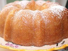 a bundt cake sitting on top of a white plate covered in powdered sugar