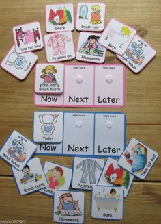 a group of cards that are on top of a wooden table with words and pictures