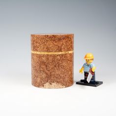 a lego figure next to a wooden container