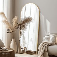 a mirror sitting on top of a table next to a couch