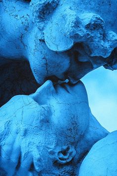 a blue sculpture with two heads on it's sides